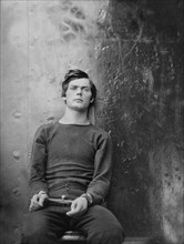 Lewis Powell, also known as Lewis Payne, Attacker of U.S. Secretary of State William H. Seward, and Conspirator in Assassination of U.S. President Abraham Lincoln, Seated and Manacled, Washington Navy...