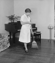 Young Woman Sweeping Floor, College Home Economics Class, Washington DC, USA, National Photo Company, December 1926