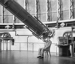 Professor H.E. Burton Looking through Telescope, U.S Naval Observatory, Washington DC, USA, National Photo Company, August 1929