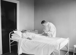 Doctor Examining Patient in Hospital, USA, National Photo Company, 1922