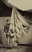 Unidentified Union Soldier Holding Tattered Flag of 37th Pennsylvania Infantry during American Civil War, USA, 1861