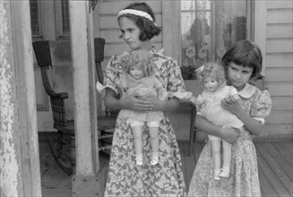 Portrait of Two Young Girls with Dolls on Porch, near Mechanicsburg, Ohio, USA, Ben Shahn for Farm Security Administration, July 1938