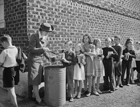 Schoolchildren Contributing to War Effort by Handing in Collected Fat and Grease, which will then be sent to Rendering Plant to extract Glycerin, Roanoke, Virginia, USA, Valentino Sarra, Office of War...