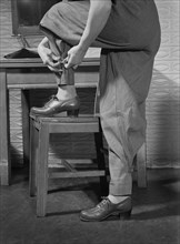 Female War Worker's Factory Uniform includes Safety Features such as Tight-Buttoning Trouser Ankles, Bendix Aviation Plant, Brooklyn, New York, USA, Ann Rosener for Office of War Information, March 19...