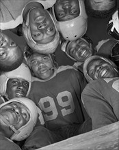Low Angle View of Football Players in Huddle, Bethune-Cookman College, Daytona Beach, Florida, USA, Gordon Parks for Office of War Information, January 1943
