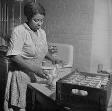 Dietician Preparing Milk for Lunch Period at Child Care Center, New Britain, Connecticut, USA, Gordon Parks for Office of War Information, June 1943