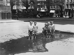 Group of Small Boys Standing in Street Puddle, New York City, New York, USA, Bain News Service, July 1913
