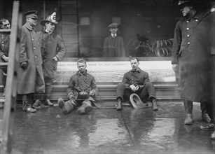 Firemen Seated on Sidewalk after Fighting Subway Tunnel Fire, West 55th Street and Broadway, New York City, New York, USA, Bain News Service, January 1915