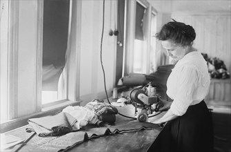Woman Cutting Flag Stripes for American Flags, Brooklyn Navy Yard, Brooklyn, New York, USA, Bain News Service, July 1917