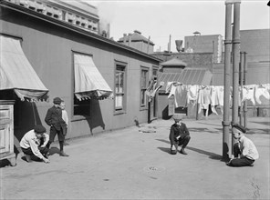 Children Playing Marbles on Apartment Building Rooftop, New York City, New York, USA, Bain News Service, 1910