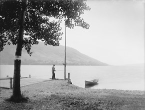 Man Fishing on Dock, Lake Skaneateles, New York, USA, Detroit Publishing Company, 1900