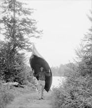 Man Carrying Canoe from Lake, Adirondack Mountains, New York, USA, William Henry Jackson for Detroit Publishing Company, 1902