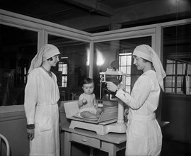 Two Female Junior League Members with Infant at Children's Hospital, Washington DC, USA, Harris & Ewing, March 1930