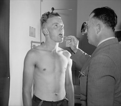 New Recruit Kemit Kuhn, 21 years old, of Bayard, West Virginia, being Examined by Army Doctor Major Seth Gayle, Jr., Washington DC, USA, Harris & Ewing, 1940