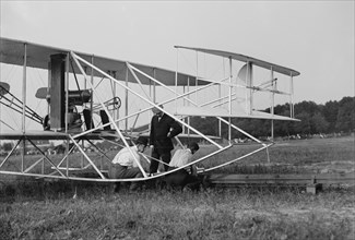 Wilbur and Orville Wright, Charlie Taylor Putting Airplane on Launching Rail, First Army Flights, Fort Myer, Virginia, USA, Harris & Ewing, July 1909