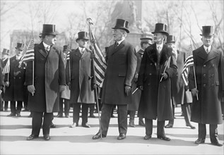 President Woodrow Wilson (center), Vice President Thomas Marshall to Wilson's left, Holding American Flags during Parade Honoring Wilson's Return from Paris Peace Conference, Washington DC, USA, Harri...