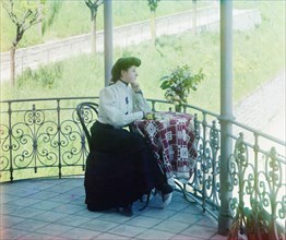 Woman in Formal Dress Sitting at Table on Balcony overlooking Field, Italy, Prokudin-Gorskii Collection, 1910