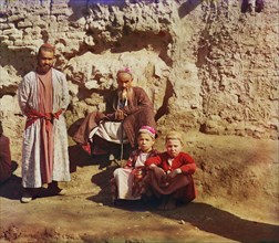 Portrait of Two Sart Men and Two Sart Boys in front of Stone Wall, Samarkand, Uzbekistan, Russian Empire, Prokudin-Gorskii Collection, 1910