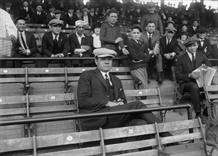 Suspended New York Yankees Baseball Player Babe Ruth, Sitting in Stands at Opening Day Game of Washington Senators versus New York Yankees, Griffith Stadium, Washington DC, USA, Harris & Ewing, April ...