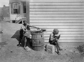Two Young Boys Eating Watermelon on Side of House, Detroit Publishing Company, 1901