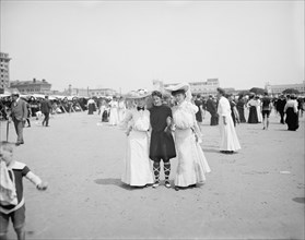 Portrait of Three Young Women Amongst Crowd at Beach, Atlantic City, New Jersey, USA, Detroit Publishing Company, 1905