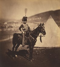 British Cornet Henry John Wilken, 11th Hussars, Seated Portrait in Uniform on Horse, Conical Military Tents in Background, Crimean War, Crimea, Ukraine, by Roger Fenton, 1855