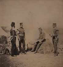 British Captain Mark Walker, 30th Regiment, Full-Length Portrait, Seated on Pile of Hay, Reading Orders to Three Soldiers with Tent in Background, Crimean War, Crimea, Ukraine, by Roger Fenton, 1855