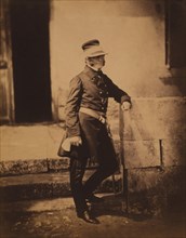 British Major-General James Bucknall Estcourt, Full-Length Portrait, Wearing Uniform and Hat with Arm Resting on Wall, Crimean War, Crimea, Ukraine, by Roger Fenton, 1855