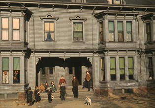 Family on Porch of Tenement Houses in Tenement District, Brockton, Massachusetts, USA, Jack Delano for Farm Security Administration - Office of War Information, December 1940