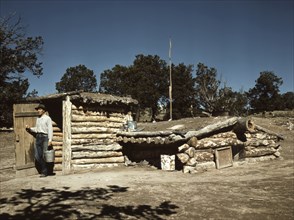 Mr. Leatherman, Homesteader, Coming out of his Dugout Home, Pie Town, New Mexico, USA, Russell Lee for Farm Security Administration - Office of War Information, September 1940
