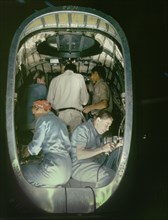 Group of Men and Women Working inside Fuselage of Liberator Bomber, Consolidated Aircraft Corp., Fort Worth, Texas, USA, Howard R. Hollem for Office of War Information, October 1942