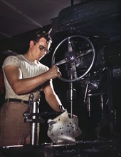 Worker in Drill-Press Section of Machine Shop running Mounting Holes in Large Dural Casting, North American Aviation, Inc., Manufacturer of B-25 Bomber and P-51 Mustang Fighter Planes, Inglewood, Cali...