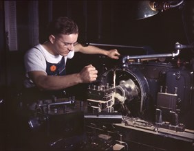 Worker in Machine Shop Finishing Aircraft Part on Huge Turret Lathe, North American Aviation, Inc., Inglewood, California, USA, Alfred T. Palmer for Office of War Information, October 1942