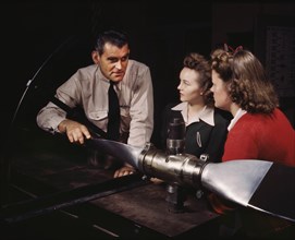 Instructor Ralph Angar Explaining Propeller Characteristics to Two Students in Aeronautics Class, while Training Students for Specific Contributions to the War Effort, Washington High School, Los Ange...