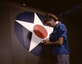 Female Worker Touching up U.S. Army Air Force's Insignia on Side of Fuselage of "Vengeance" Dive Bomber Manufactured at Vultee's Nashville Division, Tennessee, USA, Alfred T. Palmer for Office of War ...