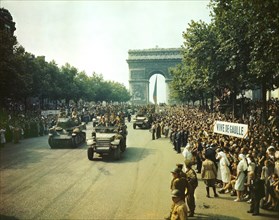Crowds of French Patriots line Champs Elysees to view Allied Tanks and half tracks pass through the Arc du Triomphe after Paris, France was Liberated on August 25, 1944, Jack Downey, Office of War Inf...