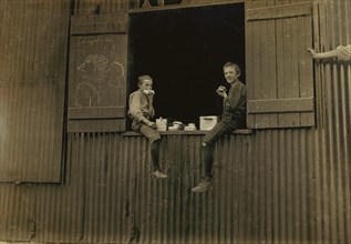 Two Young Boys eating Lunch, Economy Glass Works, Morgantown, West Virginia, USA, Lewis Hine for National Child Labor Committee, October 1908