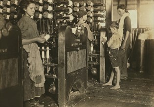 Young Girl and Boys Working in Textile Mill, Cherryville, North Carolina, USA, Lewis Hine for National Child Labor Committee, November 1908