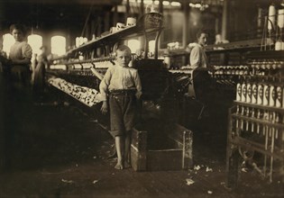 Young Eight-Year-Old Boy, 48 inches high, Picks up Bobbins at 15 cents per day, Elk Cotton Mills, Fayetteville, Tennessee, USA, Lewis Hine for National Child Labor Committee, November 1910