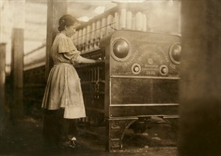Young Girl Working in Yarn Mill, Full-Length Portrait, Anniston, Alabama, USA, Lewis Hine for National Child Labor Committee, November 1910