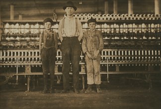 Overseer and Two Doffer Boys, Full-length Portrait, Avondale Cotton Mills, Birmingham, Alabama, USA, Lewis Hine for National Child Labor Committee, November 1910