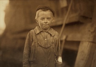 Young Doffer, said his age was 12 because he couldn't work unless he was 12, Half-Length Portrait, Birmingham, Alabama, USA, Lewis Hine for National Child Labor Committee, November 1910