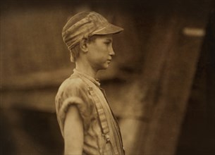 Young Doffer, Half-Length Profile, Avondale Mills, Birmingham, Alabama, USA, Lewis Hine for National Child Labor Committee, November 1910