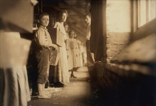 Young Doffer, Full-Length Portrait with other Workers, Richmond Spinning Mills, Chattanooga, Tennessee, USA, Lewis Hine for National Child Labor Committee, December 1910