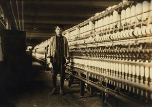 Andrew Stefanik, Young Bobbin Boy, Full-Length Portrait with Spinning Machinery, Textile Mill, Chicopee, Massachusetts, USA, Lewis Hine for National Child Labor Committee, November 1911