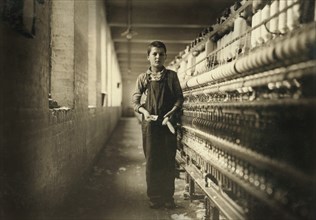Tony Soccha, Bobbin Boy, Full-Length Portrait, Spinning Room #7, Chicopee, Massachusetts, USA, Lewis Hine for National Child Labor Committee, November 1911