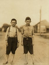 Lonny and Dewey Clark, Two Young Brothers Work as Spinners in Spinning Room of Textile Mill, Full-Length Portrait, Columbus, Georgia, USA, Lewis Hine for National Child Labor Committee, April 1913