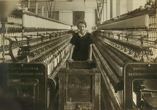 14-year-old Doffer Pushing Cart of Empty Bobbins in Card Room, King Philip Mills, Fall River, Massachusetts, USA, Lewis Hine for National Child Labor Committee, June 1916