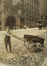 George Rabholz, 14 years old, Delivers Bundles for Printing Office, Cincinnati, Ohio, USA, Lewis Hine for National Child Labor Committee, August 1908