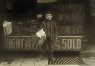 Hyman Albert, 12-year-old Newsboy, Selling for 3 years, Full-Length Portrait, New Haven, Connecticut, USA, Lewis Hine for National Child Labor Committee, October 1909